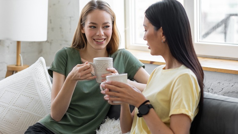 Two girl friends holding coffee