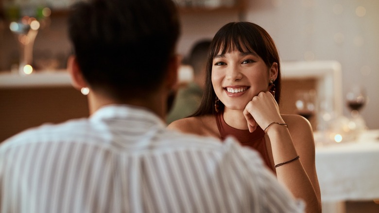 Woman smiling at a man