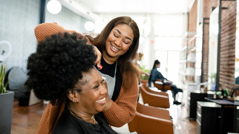 A woman getting her hair cut