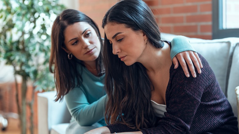 sad woman being comforted