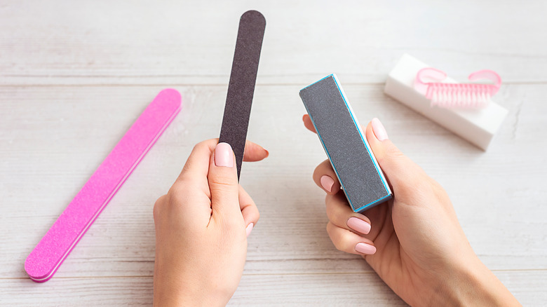 person holding different nail files