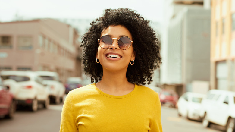 Woman wearing sunglasses, smiling