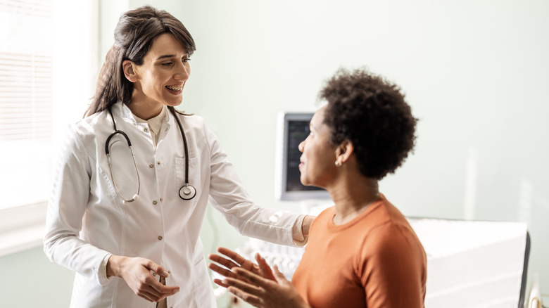 Female doctor and patient in exam room