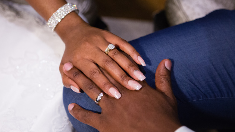 Hands wearing wedding rings