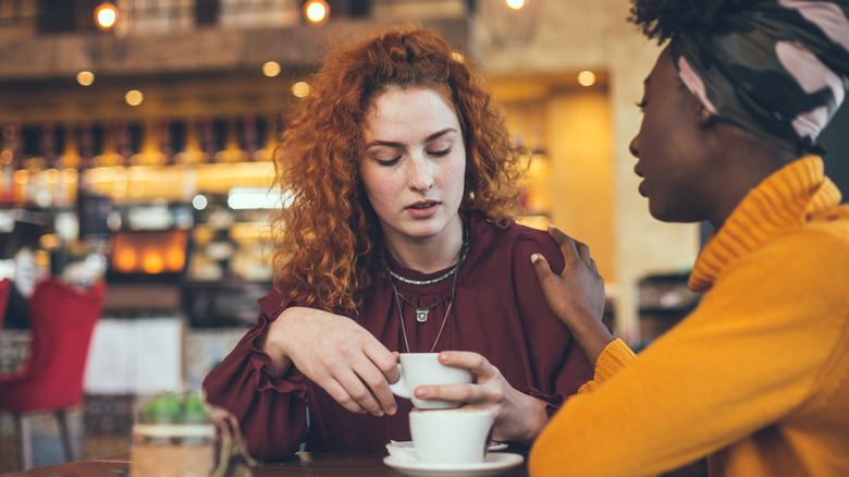 Friend comforting unhappy woman