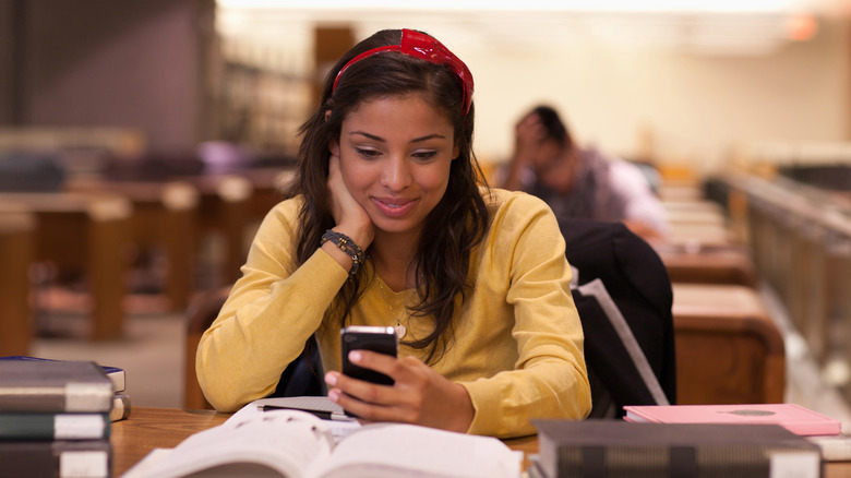 Woman on phone in library