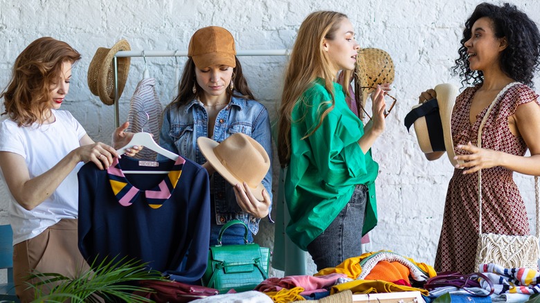 four women shopping for clothes