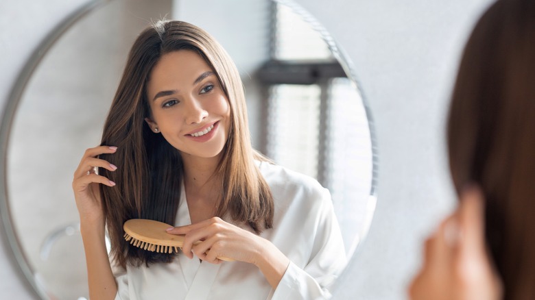 woman brushing her hair