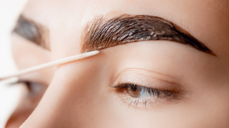 Woman tinting her eyebrows