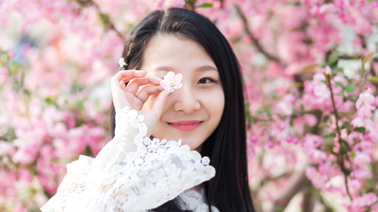 Asian woman with cherry blossoms