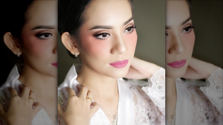 Woman applies blush