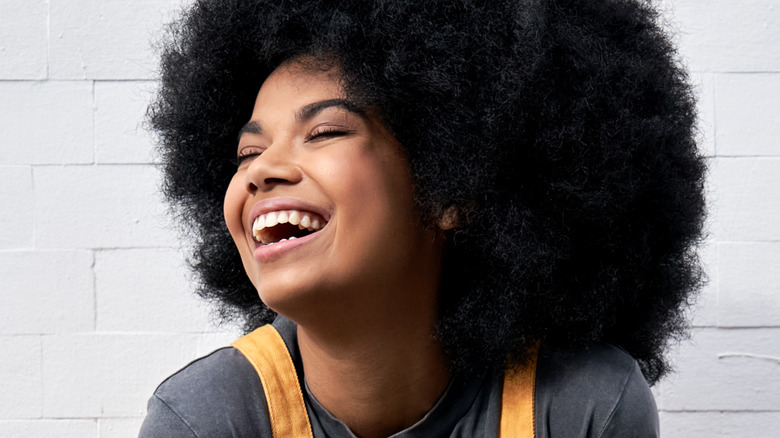 black woman with natural hair laughing