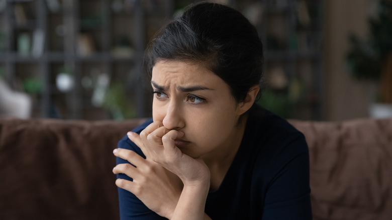 anxious woman on sofa