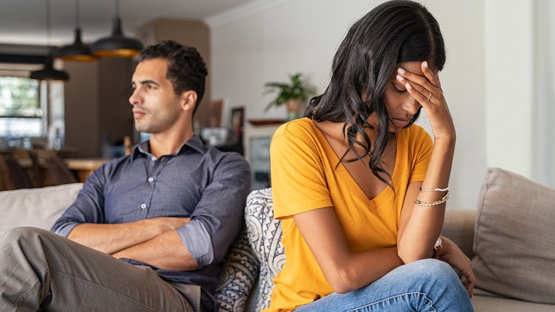 Unhappy couple on sofa