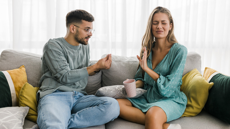 Couple arguing on sofa