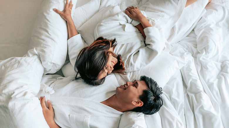 couple in robes in hotel bed