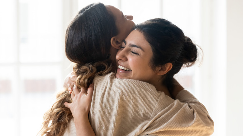 friends hugging and smiling