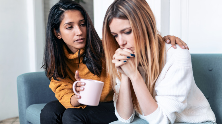 Woman comforting her sad friend