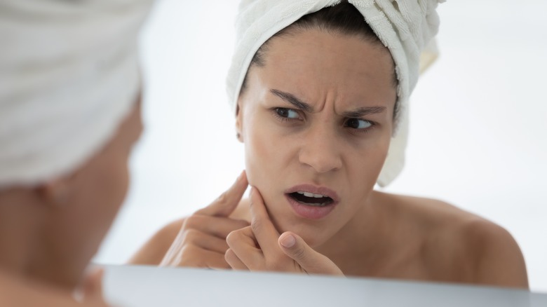 Woman looking at her skin