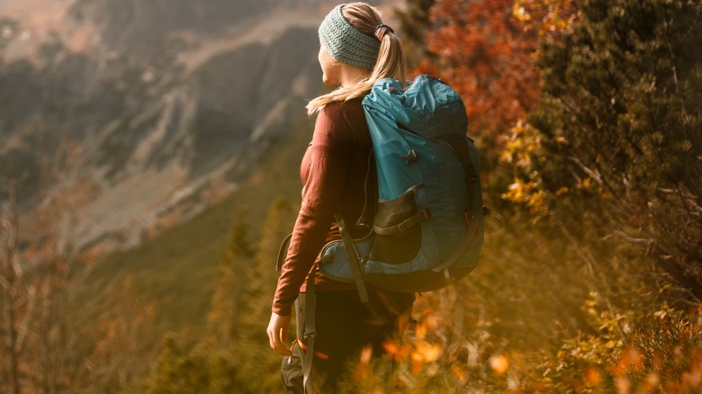 Woman hikes near mountain