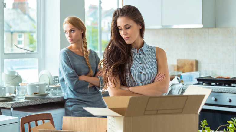 tense women with moving boxes