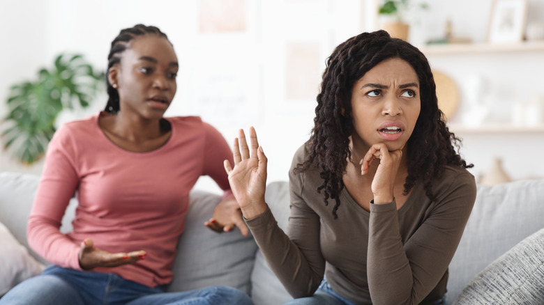 Roommates arguing on the couch