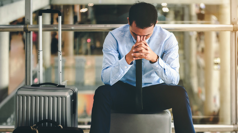 Anxious businessman sitting in airport