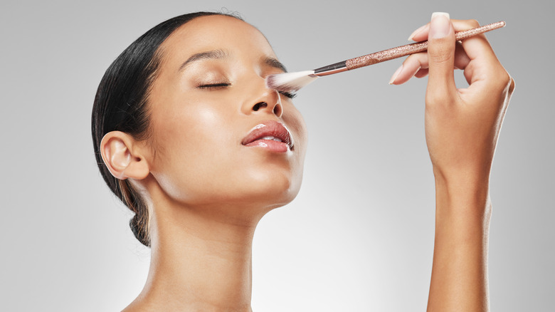 woman applying highlighter