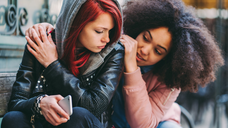 two women supporting each other