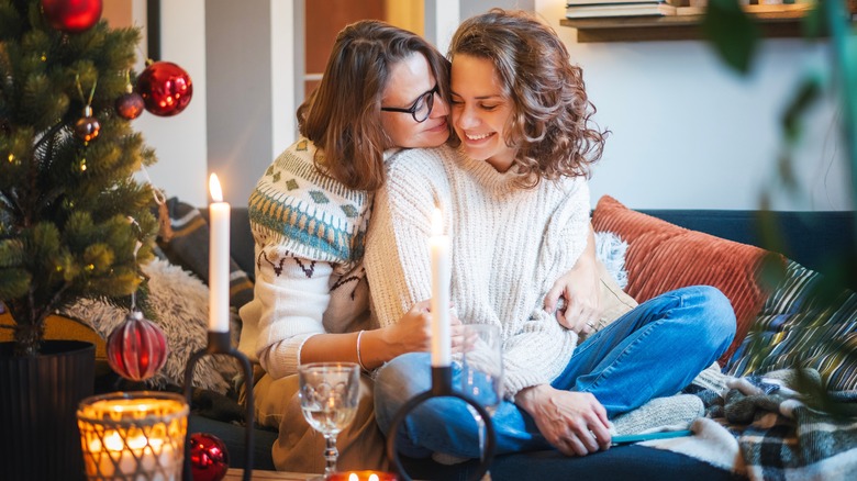 smiling couple cuddling on couch