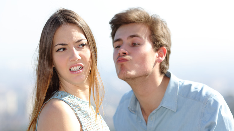 woman dodging kiss