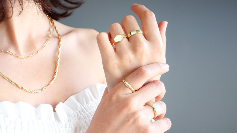 Woman's hand with gold rings