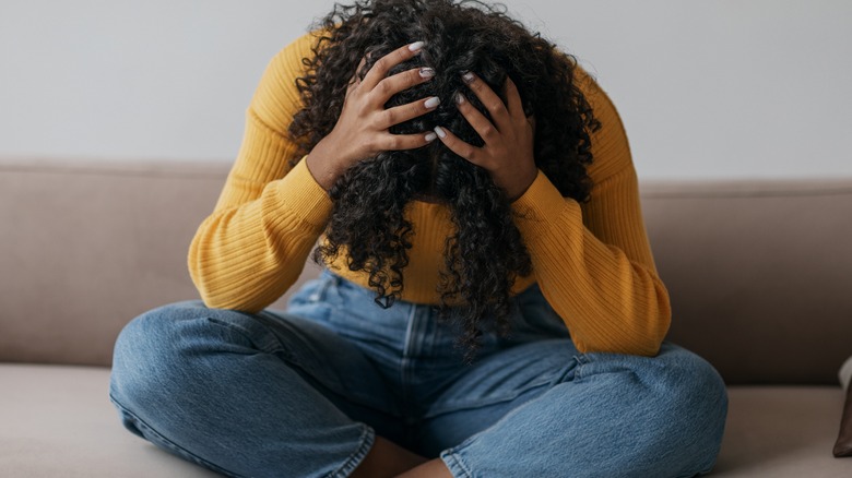 woman crying on couch