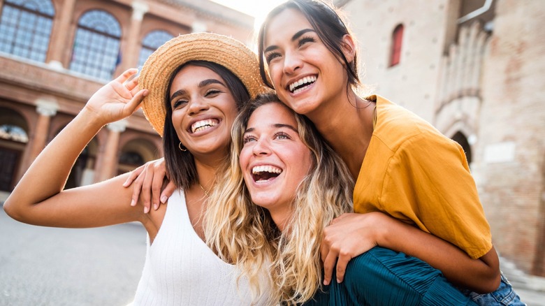 Three women smiling and laughing