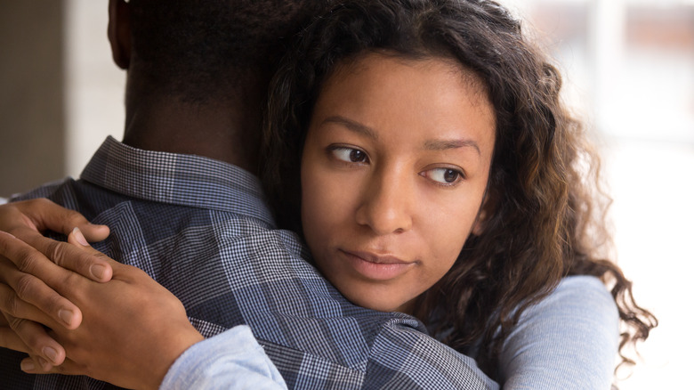 sad woman hugging partner