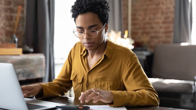 Woman completes application on laptop