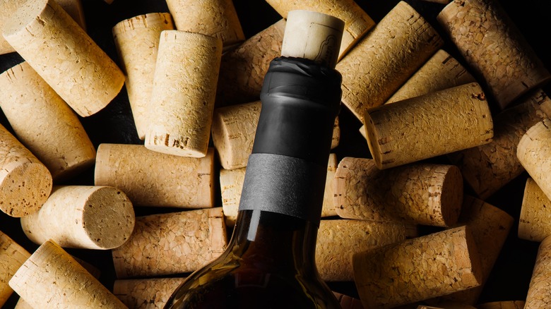 wine bottle laying over corks