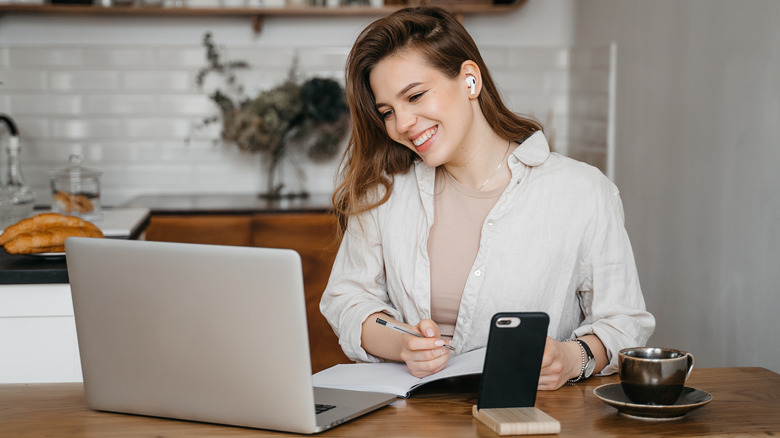 beautiful woman writing in her planner