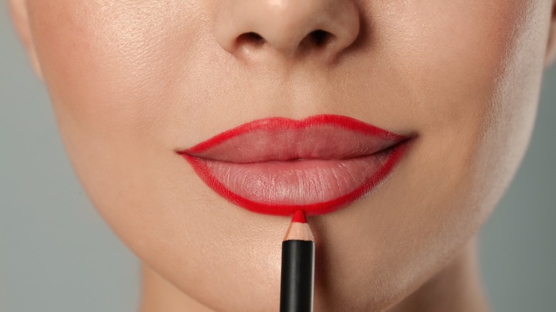 closeup of woman overlining lips