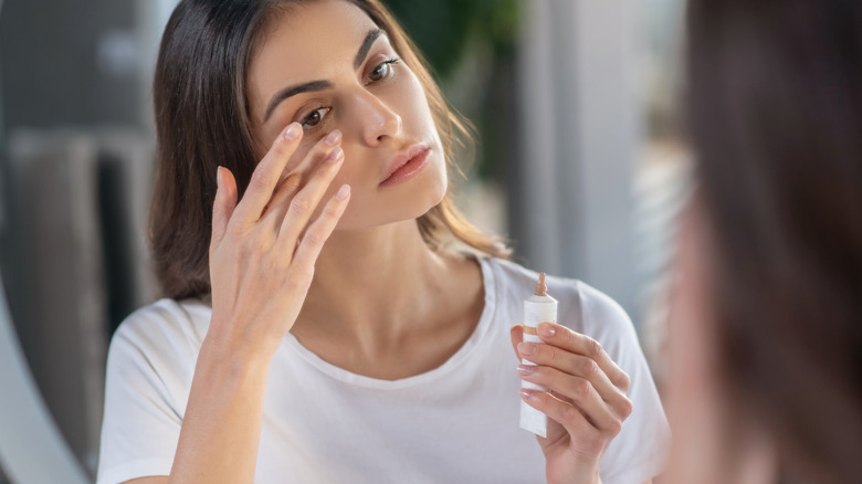 woman applying concealer