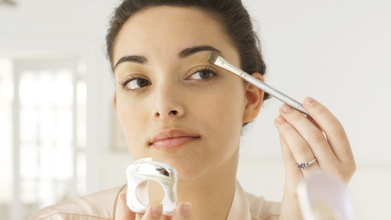 Woman applying eyeshadow