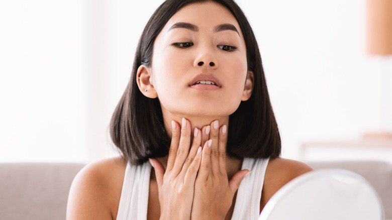 A woman massaging her neck