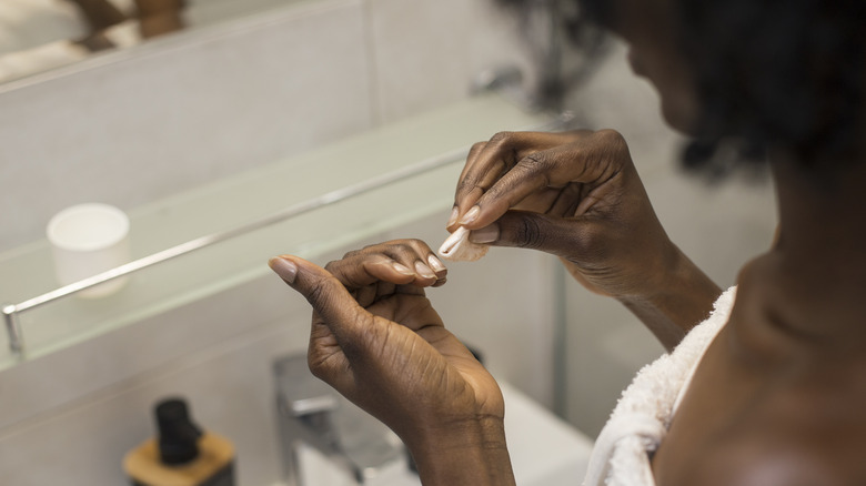 person cleaning nails