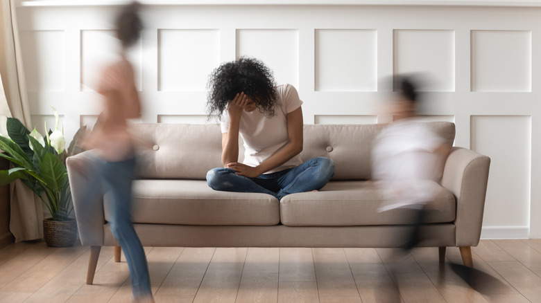 Woman holds head down