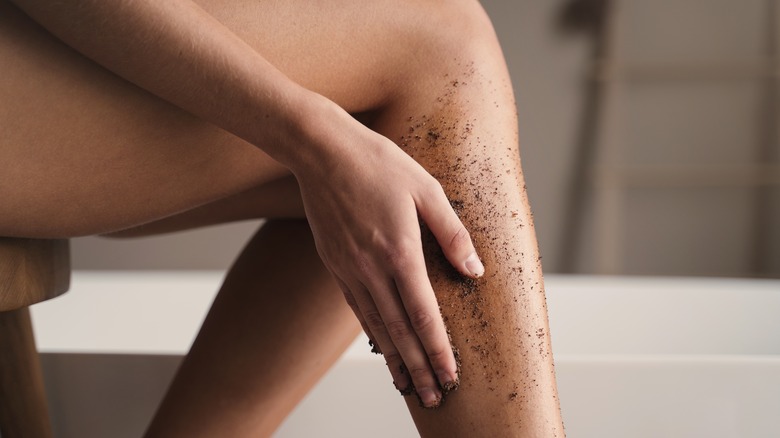 woman scrubbing legs 
