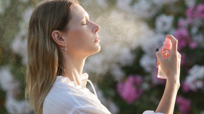 Woman spraying facial mist