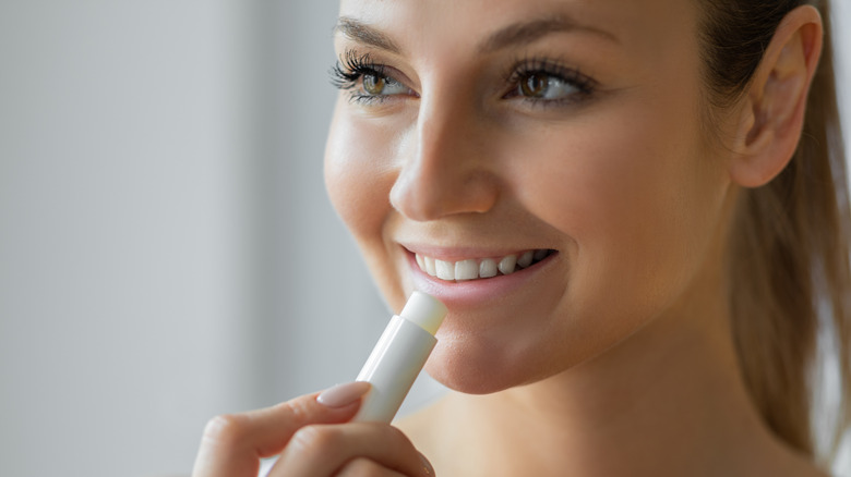 Woman applying lip product