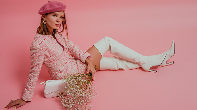 woman in pink outfit and white boots