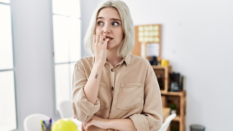 Woman biting nails