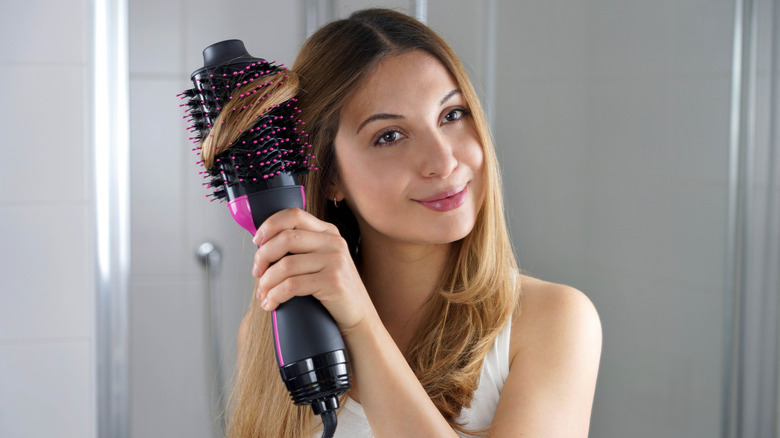 A woman using a hot air brush